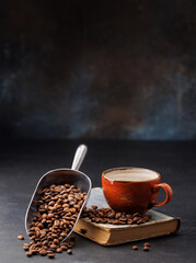 Rich coffee in a cup with aromatic roasted beans