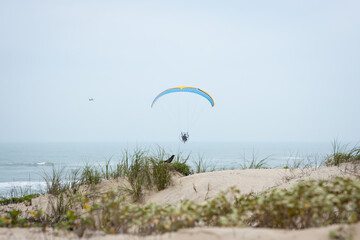Powered paragliding over ocean waves
