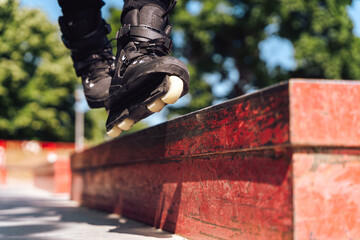 aggressive roller skater performing a trick on a railing in skatepark