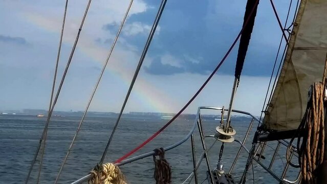 Sailing into a rainbow after a storm