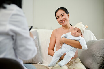 Obraz premium Adorable baby is being diagnose by doctor in the living room