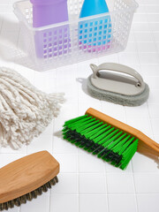 Various multifunctional brushes, rags and a basket of cleaning products. The idea of cleaning and...