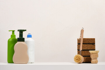 Washing dishes. Dish detergents and different sponges and brushes. Copy space for text.