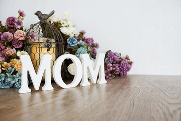 Happy Mothers day with MOM word with flower bouquet decoration