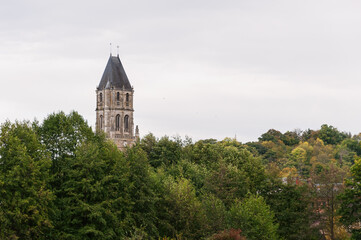 Fototapeta premium top view, among the green trees you can see the roof of an old building, close-up there is a place