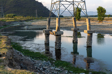 Soil erosion from the base of an electricity power transmission line tower base pillars
