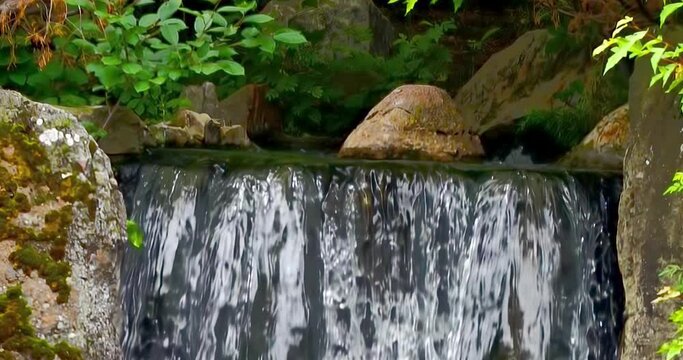 Slow motion of a water fall at a Japanese Garden in Lethbridge, Alberta, Canada. 