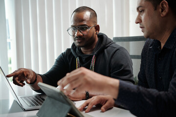 Software developer showing features in mobile application he is working on