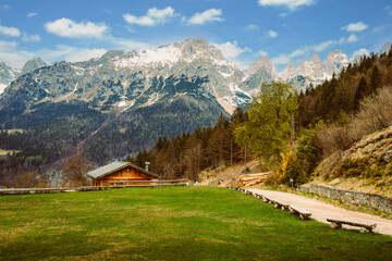 Fototapeta na wymiar Brenta Dolomites from Pradel Plateau with typical mountain wooden house