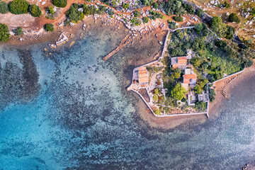 Aerial view of a villa in fishing village and harbour