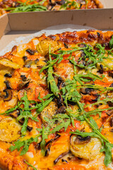 Two pan pizzas in two pizza boxes with their two different flavors