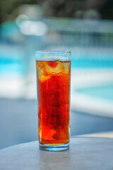A glass of fresh cocktail by the blue pool on a sunny summer day.
Beverages. Alcoholic drinks. Cocktails. Cocktail with whiskey and cola.
Glass of cold drink, cola with ice cubes, cocktail