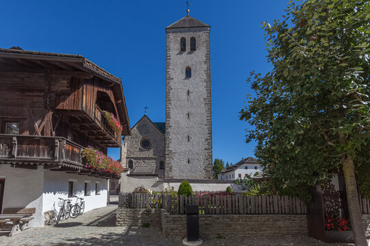 Glimpses of ancient Dolomite town of San Candido Innichen, with medieval church and traditional house. Pusteria Valley, South Tyrol, Italy