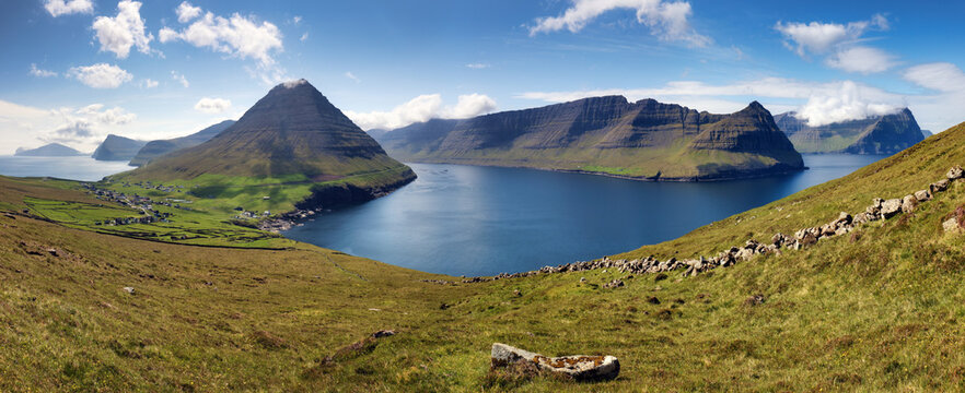 Beautiful mountain scenery with the majestic Malinsfjall mountain and Viðareiði settlement on the Viðoy the northern-most island of the Faroe Islands. Fugloy, Svínoy and Borðoy in the background.