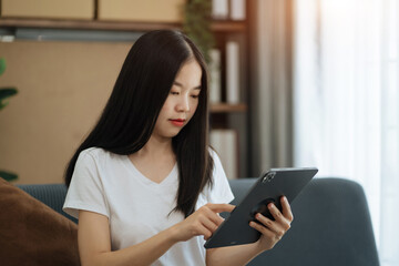Fototapeta premium lifestyle of home office workers Woman sitting on sofa and using smartphone, laptop. Home office. Work place. Lifestyle.