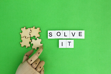 Wooden hands compile the guesses with the word solving. The concept of problem solving. The concept of q and a