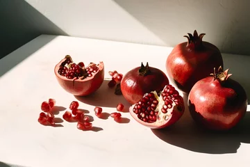 Papier Peint photo autocollant Manger Ripe pomegranates on a white background. Still life.