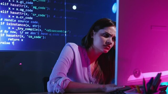 Difficulties and challenges. Concentrated young woman, web developer, programmer writing code on virtual digital screen. Coding. Concept of profession, occupation , IT, modern technologies