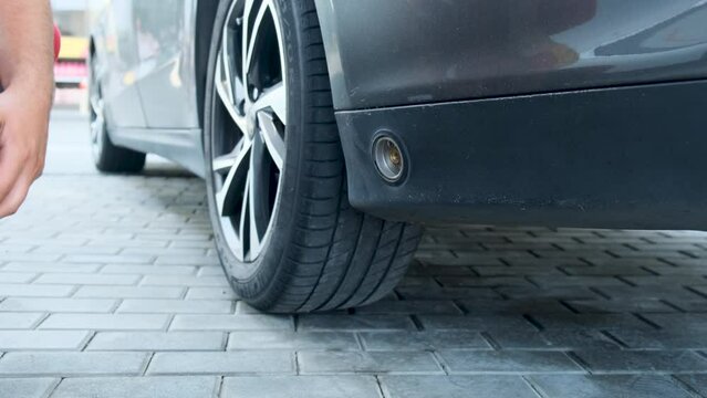 Refueling a car with lpg. Gas Station Attendant Removing LPG Delivery Nozzle from the Car LPG Tank. Filling Up the Gas Tank. Refueling with Liquefied Petroleum Gas. Close-up.