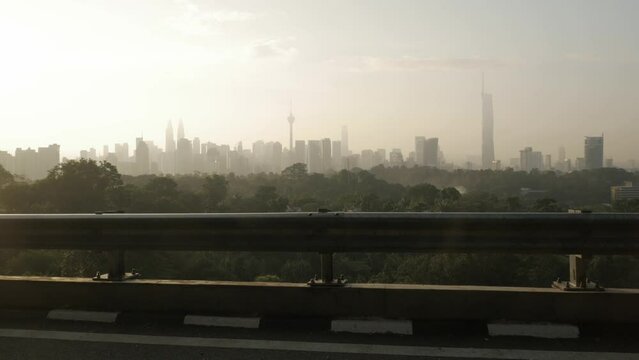 landscape view of kuala lumpur city center downtown district area with many skyscraper building highrise modern style towers with beautiful vanilla sundown sunrise