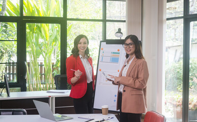 Businesswoman Using Computer in Modern Office with Colleagues.