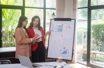 Businesswoman Using Computer in Modern Office with Colleagues.