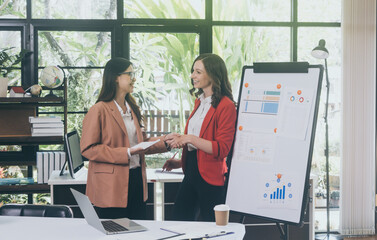 Businesswoman Using Computer in Modern Office with Colleagues.