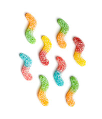 Multi-colored marmalade candies in sugar on a white background, top view.