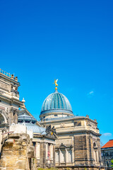 Main building of the Zitronenpresse facade and Dome with statues of golden angels as warriors and defenders in historical downtown of Dresden, Germany