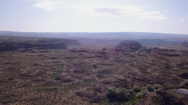 Aerial descends to Quincy Lakes Scablands landscape at Potholes Coulee