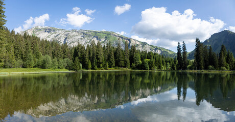 Gold miners lake or Lac des Mines d'Or with still water reflecting the spectacular nature of French...