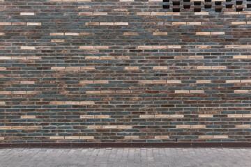 urban background - brick wall and sidewalk fragment