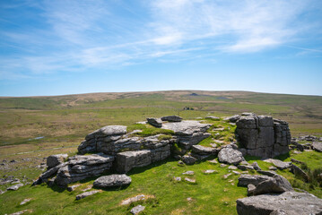 Landscape image of granite tor on Dartmoor National Park in Devon, UK