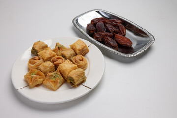 Layered stuffed pastry Baklava middle eastern sweet dessert dry ripe sweet date fruit on white background