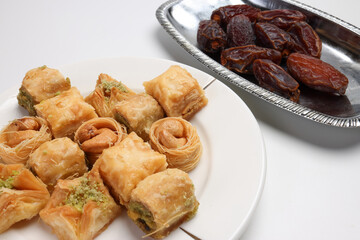 Layered stuffed pastry Baklava middle eastern sweet dessert dry ripe sweet date fruit on white background