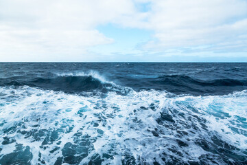 Ocean water background with foam. Ocean water splash. Not a calm