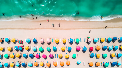 Aerial view of beautiful tropical beach with sunbeds and umbrellas.