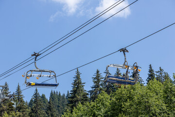 Cable car with off road bikes aside above French Alps ski town during summer sports activities. 