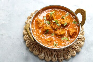 Rajasthani Gatta Curry or Besan Ke Gatte Ki Sabzi. Gatte are gram flour roundels or chickpea flour dumplings are cooked in a spicy, tangy yogurt based curry. delicacy of Rajasthan, India. copy space.