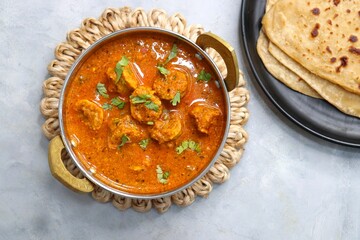 Rajasthani Gatta Curry or Besan Ke Gatte Ki Sabzi. Gatte are gram flour roundels or chickpea flour dumplings are cooked in a spicy, tangy yogurt based curry. delicacy of Rajasthan, India. copy space.