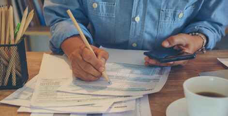 Budget and Tax planning concept, Accountant Hand is calculating company annual tax and using...