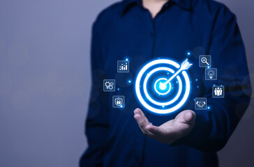 Businessman showing target virtual darts icon arrow. Goal concept for business investment. marketing strategy	
