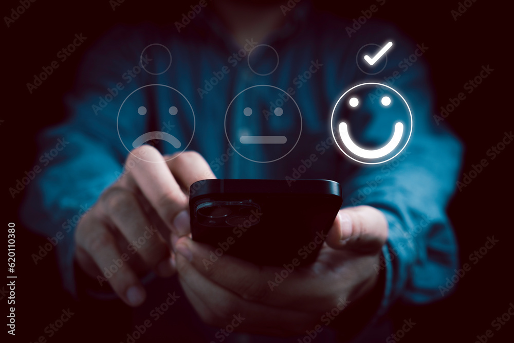 Poster businessman using smartphone to select smile face for the best evaluation from client , customer sat