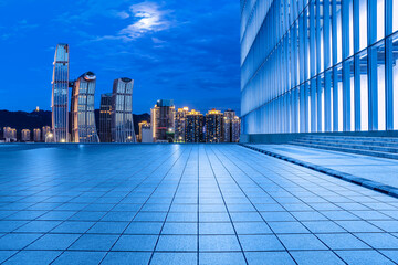 City square and skyline with modern buildings in Chongqing at night, China.