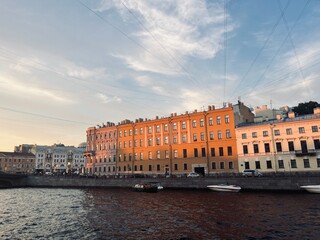 Warm evening light at the city river with historical buildings, europe old town riverside