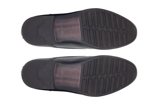 footprints, classic men's black leather shoes bottom view isolated from background