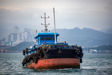 Fototapeten Large fishing boats docked by the sea in Hong Kong © Steve