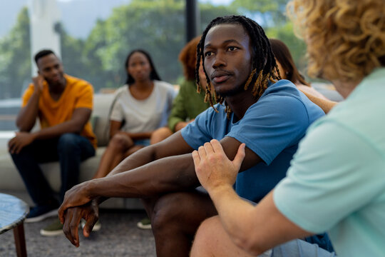 Group Of Diverse People Sitting On Sofa And Talking In Group Therapy Session