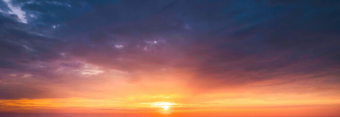 Fototapeta na wymiar Beautiful vibrant sunset sky shining over horizon during golden hour