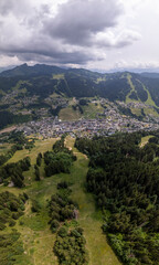 Fototapeta na wymiar https://submit.shutterstock.com/pending#:~:text=Vertical%20aerial%20showing%20valley%20with%20Les%20Gets%20outdoor%20sports%20holiday%20destination%20surrounded%20by%20the%20green%20French%20Alps%20se
